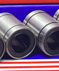 Four LME16UU linear motion ball bearings for 16 mm shafts, ideal for CNC routers, smooth sliding, displayed in a row.