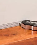 Heavy Duty Aluminum Carpentry Scribe Tool With Dead On Built In Stud Detector And Eight Exact Offsets For Swift Wall Marking Easy Corner Reach and Knockout Cabinet Installations on wooden surface.