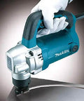 Gloved hand holding Powerful 710W Nibbler With 3.2 mm Capacity, soft grip ergonomic handle, cutting metal with chip clearance from below.