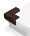 Durable Corner Guards For Furniture And Fireplaces 12 pack brown NBR shock absorbing edge protectors installed on table corner