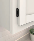 Close-up of Heavy Duty Steel Cabinet Hinges Matte Black For Face Frame Doors, fitted to white cabinet with half inch overlay.