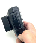 Hand holding Universal CB Radio Microphone Holder Mount with adhesive backing, pre-drill holes, T Tab clip, belt clip and round knob.