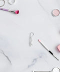 8 Pack Heavy Duty Stainless Steel Cotter Pins With Wavy Design on a marble surface among beauty products and tools.