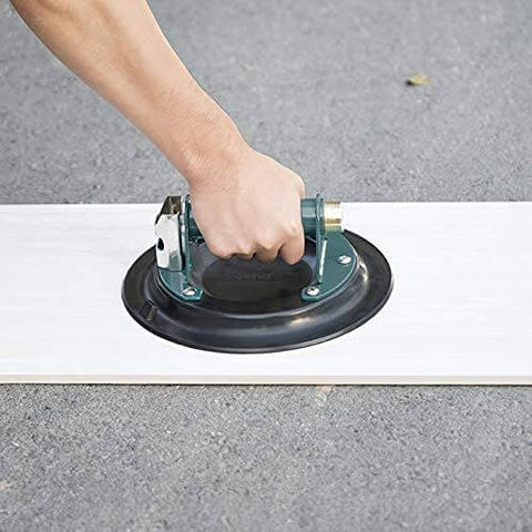 Close-up of 10 Inch Vacuum Suction Cup Lifter For Granite And Glass With Metal Handle And Brass Pump in use on white surface