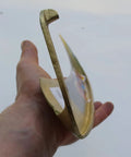 Side view of hand holding Hand Forged In Austria Scythe Blade With Curved Edge For Easy Harvest, 30 Inch Blade, Dual Sweep Options