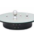 Smooth Moves Motorized Rotating Display Turntable Platform 7.87 Inch Black with pearls on glass surface and control buttons.