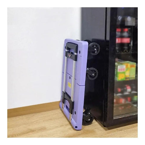 Heavy Duty Folding Platform Cart With Smooth Ball Casters folded flat against a wall, showing its compact design and wheels.