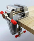 Solid Mini Workbench Vise Rig With A Three Point Five Inch Heavy Aluminum Jaw Precision Clamping Tool For Jewelry Crafts Woodworking Hustle And Snappy Electronic Repair Jobs on wooden surface.