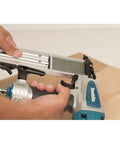 Close-up of Rock Solid 18 Gauge Brad Nailer with lightweight aluminum frame, loading brad nails for carpentry.