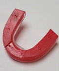 Red mouthguard for peak performance and jaw protection, reduces G forces, boosts strength and stamina, helps you speak clearly and breathe easy.