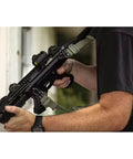 Game Changer Universal QD Wire Loop That Locks Dead Sure On 1.25 Inch Slings mounted on a tactical rifle with a green sling.