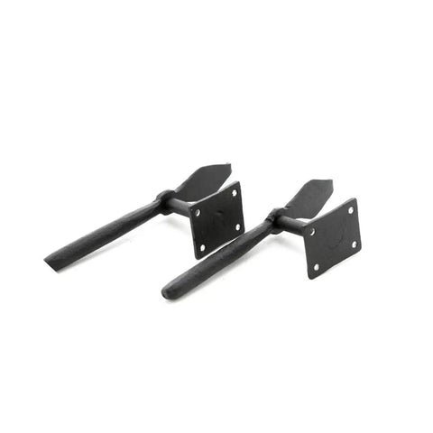 7 Inch Black Spoon Shaped Wrought Iron Shutter Dogs With Mounting Hardware Pack Of 6 For Exterior Shutters, two shown flat on surface
