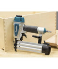 Rock Solid 18 Gauge Brad Nailer with Slick Trigger and Compact Narrow Nose, driving nails into wood for carpentry.