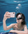 Woman using Wide Field Diving Mask For Snorkeling And Spearfishing With Anti Fog Silicone Goggles in a pool, smiling and taking a selfie.
