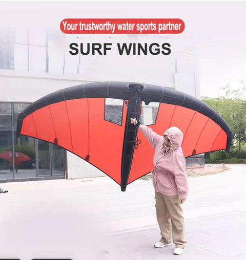 Person holding red Inflatable Wing With Pump For Paddle Board And Hydrofoil, Wing Foil Kite For Windsurfing