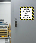 Keep Clear Do Not Block Sign 17 By 17 Inches 5 Pack Self Adhesive Waterproof Vinyl Safety Stickers installed on warehouse door