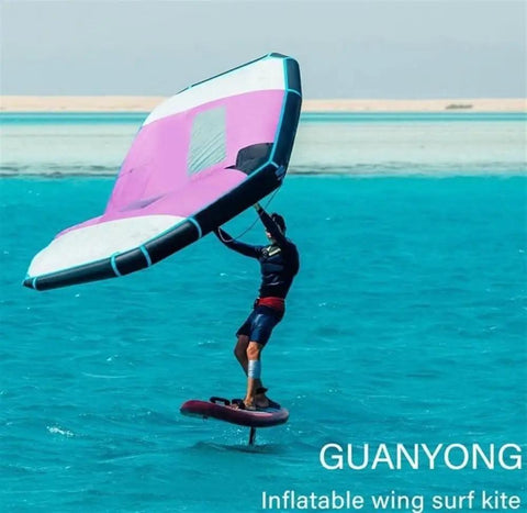 Person using Inflatable Wing Foil For Water Sports With Handheld Surf Wing Dope Setup on a bright blue sea.
