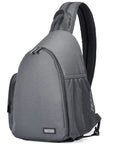 Grey camera gear backpack with quick-access front zippers, waterproof shockproof travel bag for photographers, side view.