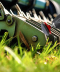Easy No Fuss Dull Blade Sharpener Kit For Lawn Mowers And Garden Tools attached to a drill sharpening a lawn mower blade