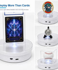 Elevate Your Stack With This Badass Motorized 360 Spinning Turntable Display Stand Featuring An Led Lit Rechargeable Base And Secure Acrylic Slot For Psa Graded Slabs Sports Cards And Coin Collections Smooth Rotation Guaranteed showcasing various collectibles like a card, coin, and baseball.