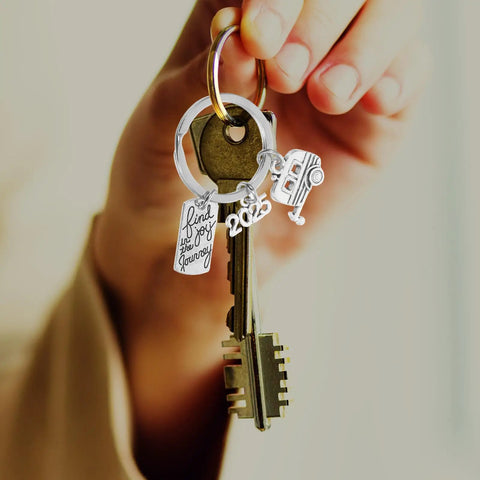 Hand holding Silver Zinc Alloy Keychain For Travel Buffs Easy To Attach And Detach Keys Compact Cute Key Ring For Vacations