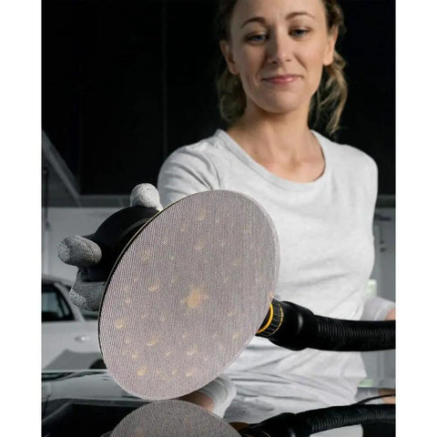 Woman using 6 Inch Sanding Discs Pack With Hook And Loop Mesh Pads For Orbital Sanders, dust free sanding on automotive surface.