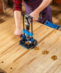 Edge Guide Drill Jig for consistent edge distance holes in use on a workbench, creating shelf pin holes with a drill.