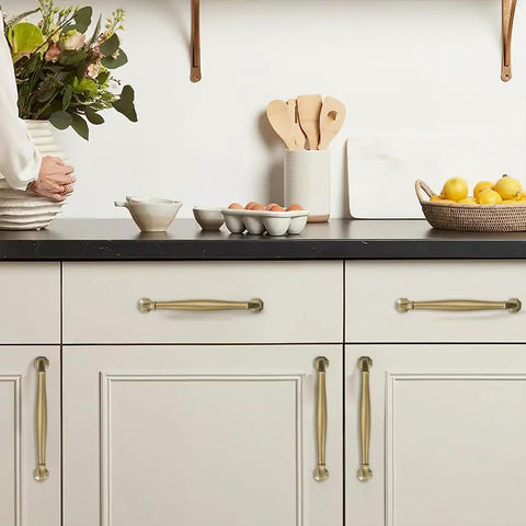 Top Shelf Brushed Brass Cabinet Pulls 10 Pack 5 Inch Center To Center Heavy Duty Solid Metal Handles Warm Gold Finish used on kitchen drawers.