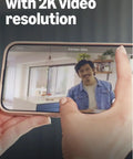 Smartphone displaying 2K video feed with Tiny 2K Plus Plug In Indoor Security Camera Kit with Night Vision, Crisp Audio, Motion Alerts.