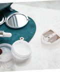 Game Changing Solar Powered Motorized Jewelry Turntable Featuring A Slick 360 Degree Rotation Designed To Show Off And Secure Your Collection For Retail Shops Or Home Use on marble surface with cosmetics.