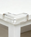 Close-up of corner with 4 Pack PVC Safety Corner Guards For Tables And Furniture Kid Safe Edge Protectors To Stop Bumps Soft Cushions.