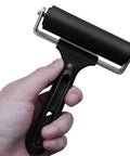 4 Inch Rubber Brayer Roller For Flooring Installations And Decking, Heavy Duty Glue Roller in hand showing black handle and steel frame