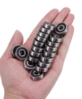 Hand holding 100 Pack 608 Bearings Pre Lubricated Deep Groove Ball Bearings 8x22x7mm C3 High Speed Double Sealed