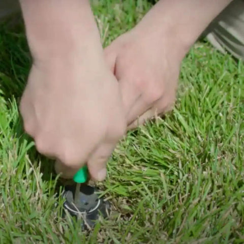 Go To Rotor Pull Up Tool And Adjustment Screwdriver For Geared Irrigation Rotors All In One Lift Tool With Thin Flat Head Screwdriver Corrosion Resistant Metal With Green Handle Fits Most Geared Rotors And Brands Easy Lift And Fine Tune, hands adjusting sprinkler in grass
