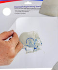 Person peeling sheet from Pro Grade Multi Layered Disposable Paper Body Filler Mixing Board With 100 Sheets, resin surface visible.