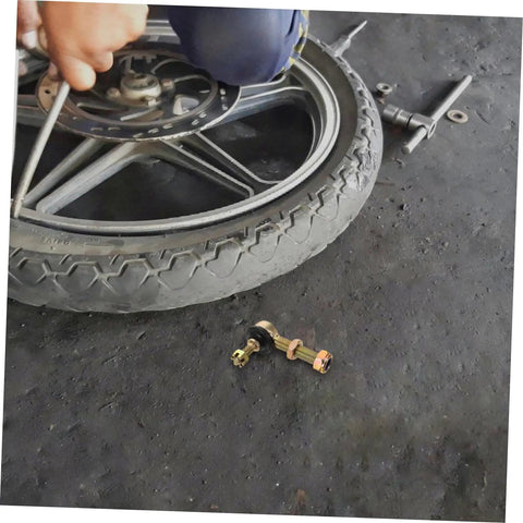 Beefed Up Off Road Ball Joint Kit For ATVs With Adjustable Suspension And Tapered Tie Rods next to a tire on concrete floor