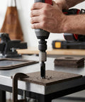 Hand holding Sick And Serious Power Hole Punch Lacing Tool For Conveyor Belts With 1/2 Inch Drive Alloy Steel Build.