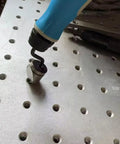 NG1000-BC1651 deburring tool with blue handle and 90-degree countersink bit on perforated metal plate