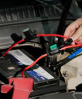 Waterproof Inline Fuse Holder 12 Volt 14 AWG 2 Pack with 20A blade fuse connected to an automotive battery.