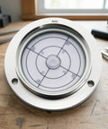 MotiveTech Horizontal Circular Bubble Level | 80mm, Flange-Mounted Spirit Level, Precision, for Alignment Checks, Installers, Machinists, Style D on wooden surface.