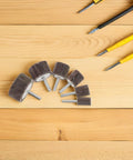 12 Piece Brown Abrasive Flap Sanding Wheels Set For Drill Press Deburring And Metal Finishing Heads Assortment Tool Kit Fast Burr Removal arranged on wooden surface.