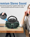 Portable CD Player Bluetooth Boombox with AM FM Radio USB Aux In Headphone Jack MP3 CD Compatible on a table, focus on speakers and controls