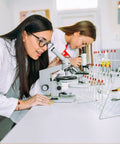 Chill Out Your Lab Setup With This Sleek White Metal Test Tube Drying Rack. Two students using a microscope in a lab setting.