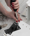 Person installing Heavy Duty 360 Degree Hidden Door Hinge In Matte Black Stainless Steel With Concealed Pivot For Cabinets And Secret Bookcase Doors Smooth Glide Bearing System That Resists Jams And Handles Heavy Loads on white panel
