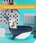 Pastail Medium Whale Shaped Pasta Colander For Draining Pasta Vegetables And Fruit, shown next to gift boxes, standing on fins.