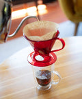 Size 6 Cone Coffee Filters White 40 Count Per Pack Pack Of 12 480 Total Filters Packaging May Vary Ideal For All 10 Cup Non Electric Cone Coffee Makers Delivers Cleaner Taste For A Smooth Cafe Quality Brew in use with red dripper and glass mug