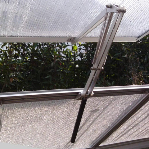 Solar Powered Greenhouse Window Opener, Heat Sensitive Auto Vent Kit with two springs and aluminum frame installed on greenhouse.