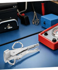 Tough As Nails Heavy Duty Auto Body Frame Clamp with Extra Wide Duckbill Jaw on workshop table, used for welding and car repair