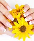 French manicured nails holding yellow flowers, prepared with Mini Nail Buffer Blocks Set 100 180 Grit For Nail Prep And Gel Polish Sponge Buffing Sanding Blocks File Kit Pro Grade Bulk 50 Pcs Pink For Home And Salon Manicures Nail Art Prep Smooth Finish