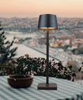 Rechargeable Cordless LED Desk Lamp with Lightweight Aluminum Body on outdoor table, showcasing 360 Degree Lighting